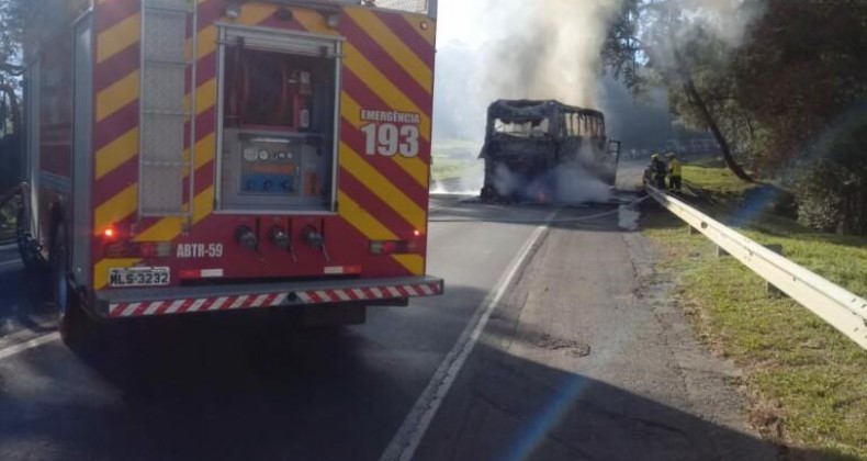 Ônibus de viagem particular é destruído por incêndio em rodovia.